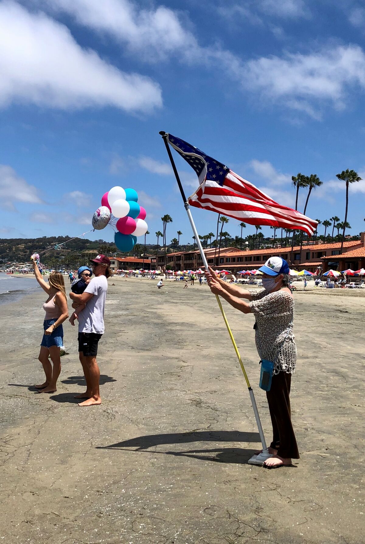Friends and family members of La Jollan Laura McDonald await her at La Jolla Shores after she completed a 4-mile swim.