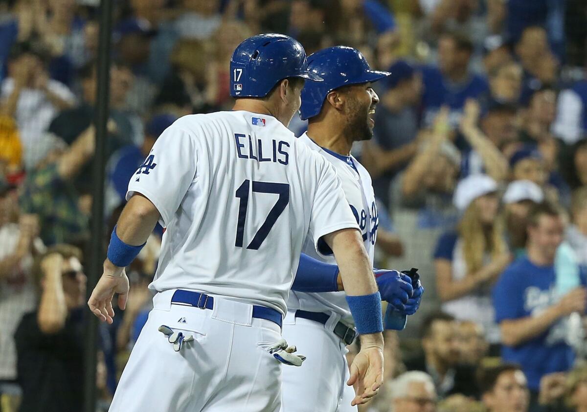 A.J. Ellis and Matt Kemp celebrate after scoring on a three-run double from pitcher Dan Haren in the fourth inning of the Dodgers' 6-4 win over the Arizona Diamondbacks.