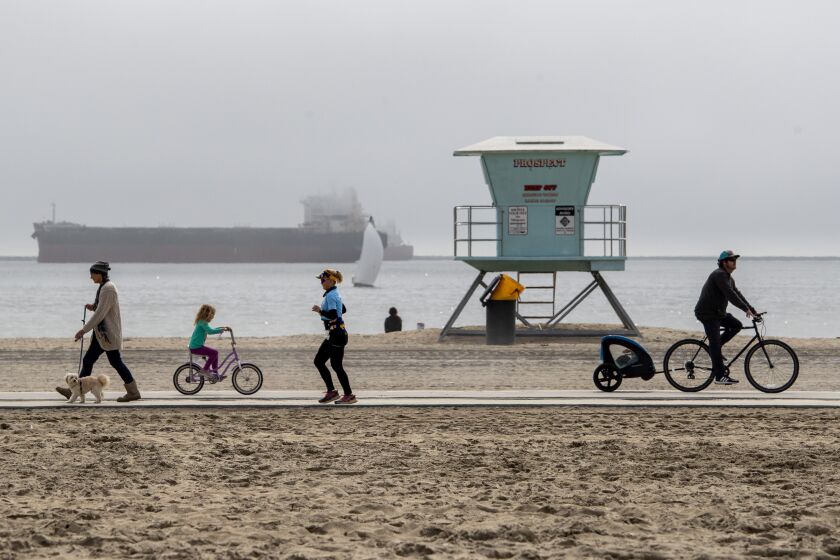 LONG BEACH, CA - MARCH 11: Rain yielded to gray skies and low clouds as Southern Californians ventured outside for activities along Granda Beach on a dry but overcast Saturday March 11, 2023 in Long Beach, CA. (Brian van der Brug / Los Angeles Times)