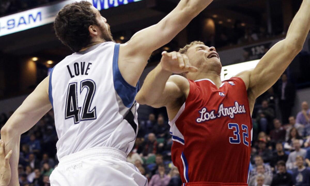 Clippers forward Blake Griffin, right, puts up a shot in front of Minnesota Timberwolves forward Kevin Love during the Clippers' 102-98 win on Nov. 20.