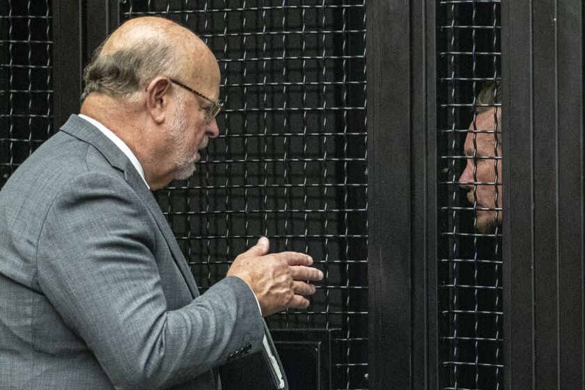 SANTA ANA, CA - AUGUST 07, 2019 Ñ Defense attorney Robert Sanger, left, talks to Peter Chadwick at pretrial hearing held on Wednesday August 07, 2019 in Santa Ana. Chadwick is charged with killing his wife in their Newport Beach home. A tip ended a years-long manhunt for Chadwick, an Orange County multimillionaire accused of killing his wife and dumping her body before fleeing to Mexico to avoid prosecution. (Irfan Khan/Los Angeles Times)