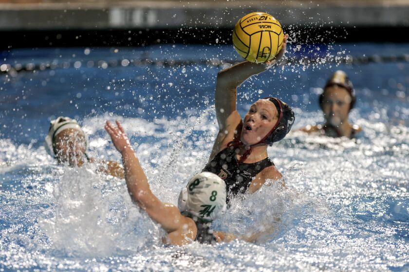 SAN DIEGO, CA - FEBRUARY 18, 2023: Bishop's Kendal Wyer looks to pass the ball as Helix's Elizabeth Spiller defends during the first half of the CIF girls water polo Open Division final at the Coggan Family Aquatic Complex in La Jolla on Saturday, February 18, 2023. (Hayne Palmour IV / For The San Diego Union-Tribune)