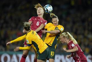 Denmark's Karen Holmgaard, top left, and Australia's Emily Van Egmond, top right, jump for the ball.
