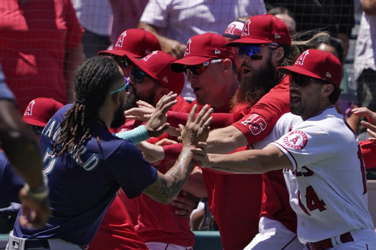 Seattle's J.P. Crawford, left, confronts several Angels players during Sunday's bench-clearing brawl.