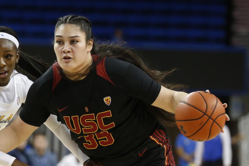 LOS ANGELES, CALIF. -- SUNDAY, DECEMBER 29, 2019: USC Trojans forward Alissa Pili (35) gets around UCLA Bruins forward Michaela Onyenwere (21) in the first half at Pauley Pavilion in Los Angeles, Calif., on Dec. 29, 2019. (Gary Coronado / Los Angeles Times)