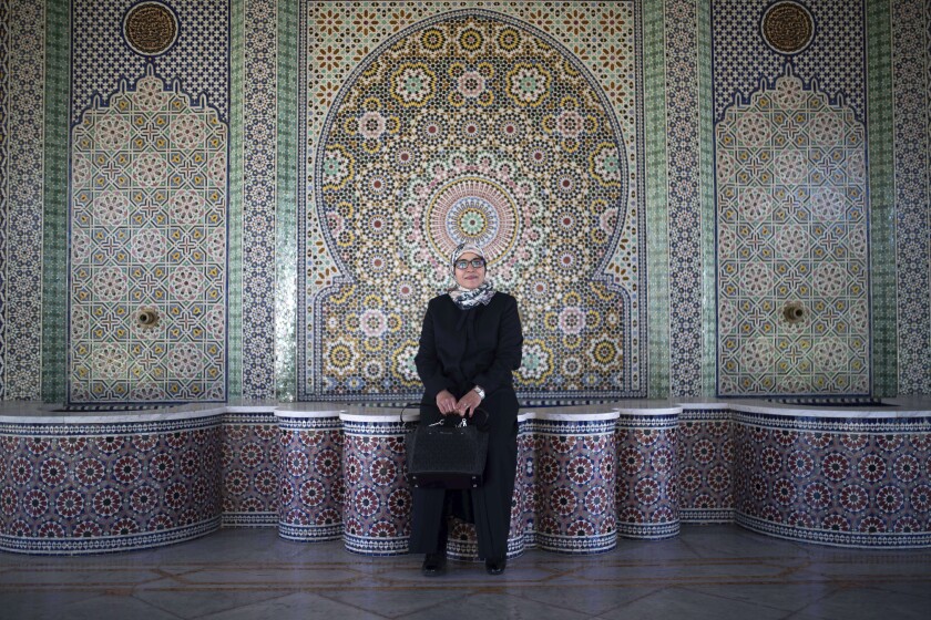 Aziza Moufid, 40, a female Muslim religious guide, or mourchida, poses for a portrait in Lalla Soukaina mosque, named after the daughter of the late King Hassan II, in Hay Riad neighborhood of Rabat, Morocco, Tuesday, Nov. 9, 2021. During the pandemic, Moufid has been using WhatsApp to explain sayings of the Prophet Muhammad to children, to help women learning to memorize and recite the Quran and to counsel teenage girls. (AP Photo/Mosa'ab Elshamy)