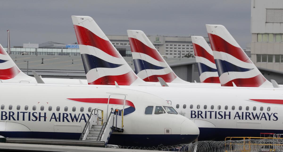 FILE - British Airways planes parked at Terminal 5 Heathrow airport in London, Wednesday, March 18, 2020. British travelers going abroad for the Easter holidays faced disruptions Monday, April 4, 2022 as two main carriers, British Airways and easyJet, canceled dozens of flights due to staff shortages related to soaring cases of COVID-19 in the U.K. Budget carrier easyJet grounded 62 flights scheduled for Monday after canceling at least 222 flights over the weekend. (AP Photo/Frank Augstein, File)