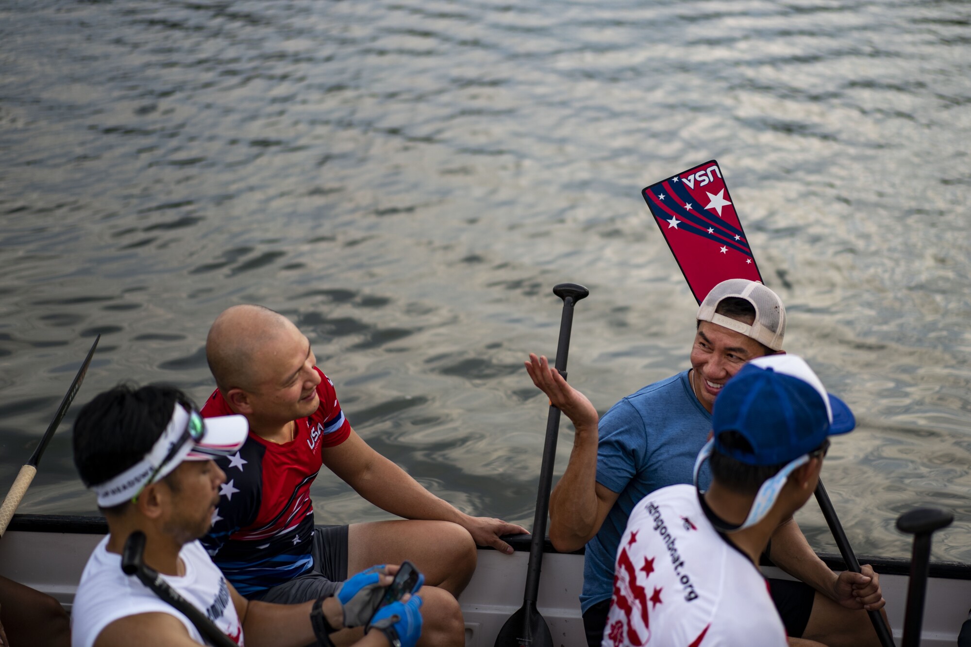 Coach Troy Pham, left in red, chats with Vu Deo during practice.