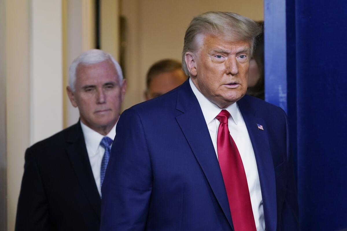 President Donald Trump and Vice President Mike Pence walk into the Brady Briefing Room at the White House.