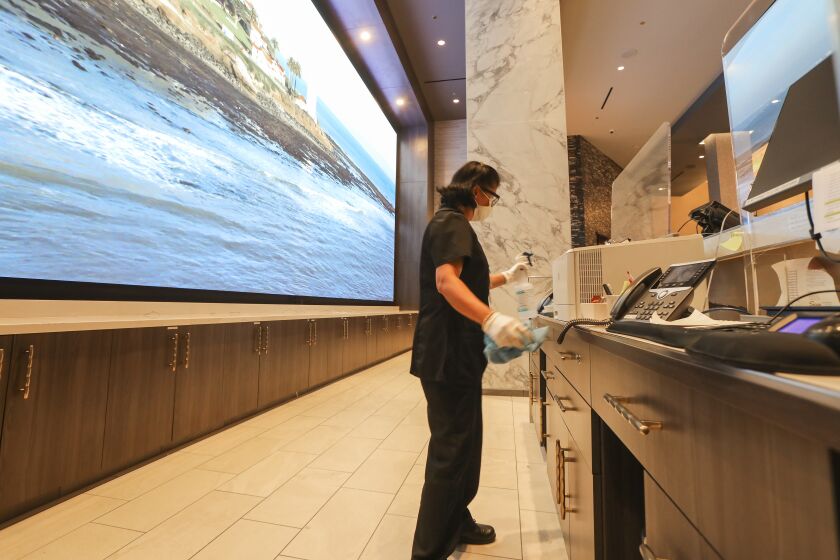 Preparing for their reopen, Jane Santo Domingo, an environmental services worker, cleans the front desk area at Sycuan Casino on May 15, 2020 in El Cajon, California.