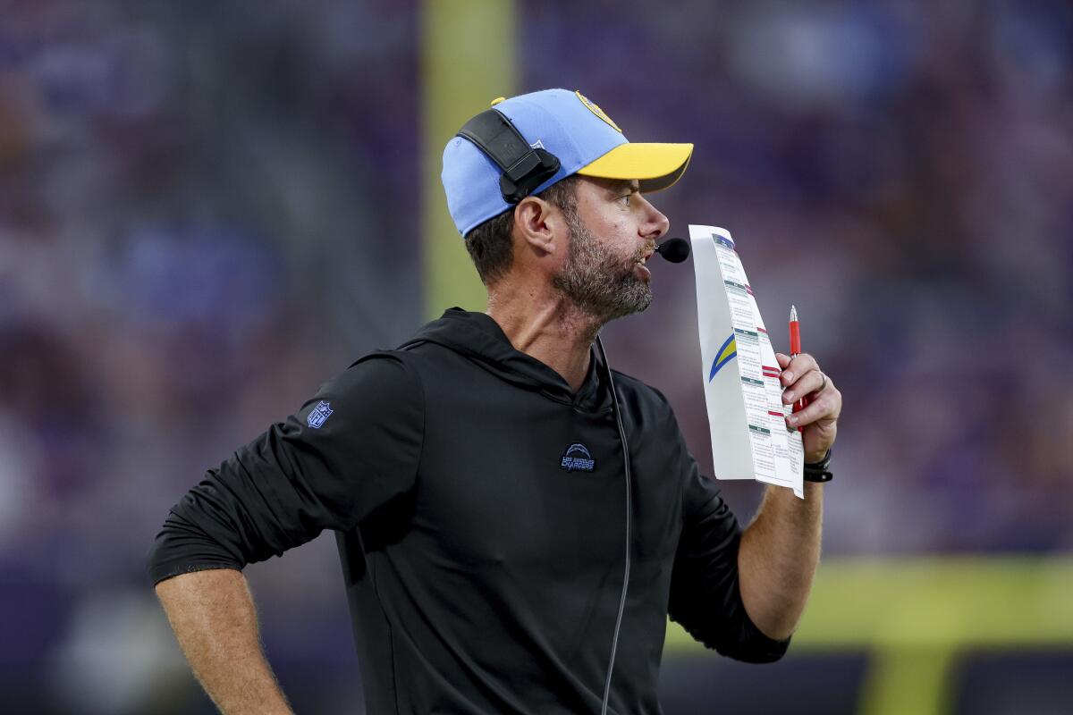  Chargers head coach Brandon Staley calls a play from the sideline.