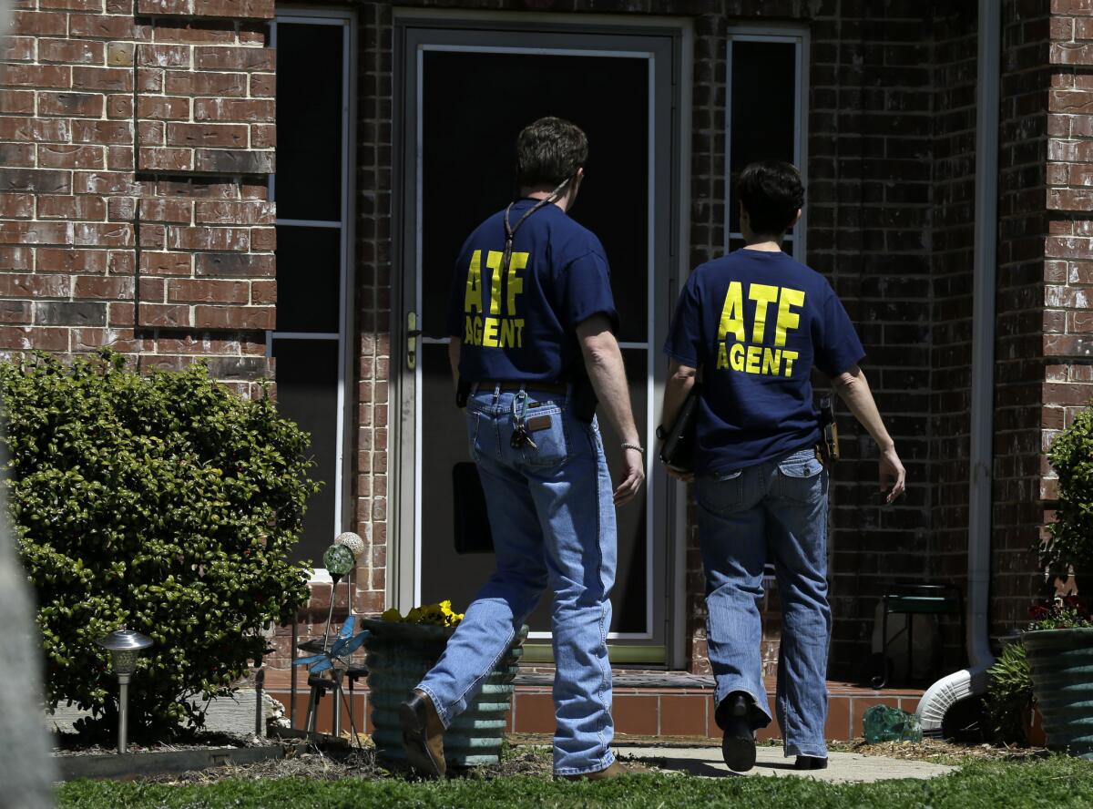 Agents from the federal Bureau of Alcohol, Tobacco, Firearms and Explosives enter the home of Kaufman County, Texas, Dist. Atty. Mike McLelland on Monday as the investigation into the slayings of McLelland and his wife continues.
