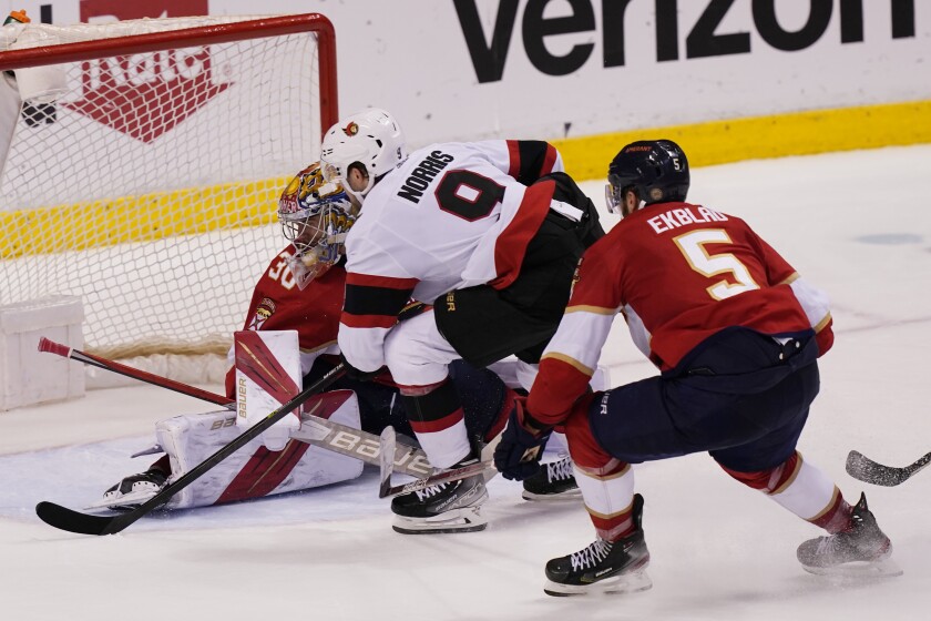 Ottawa Senators center Josh Norris (9) scores a goal against Florida Panthers goaltender Spencer Knight (30) during the second period at an NHL hockey game, Tuesday, Dec. 14, 2021, in Sunrise, Fla. (AP Photo/Marta Lavandier)