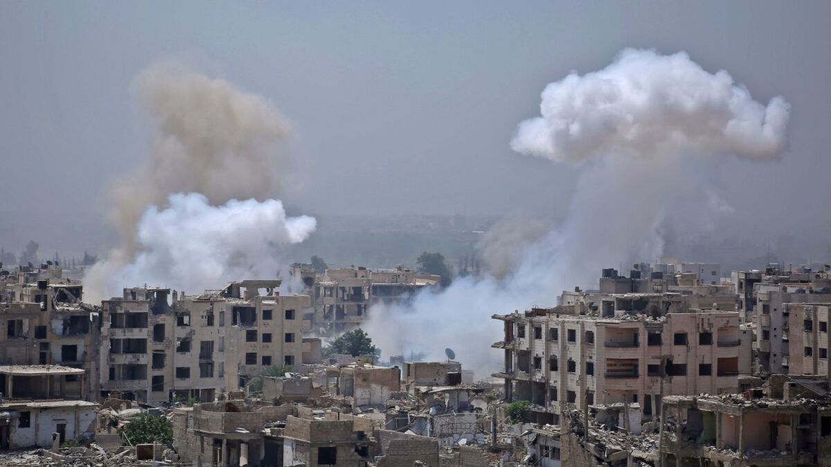 Smoke billows after a reported airstrike by Syrian government forces in the rebel-held parts of the Jobar district on the eastern outskirts of Damascus on Aug. 9.