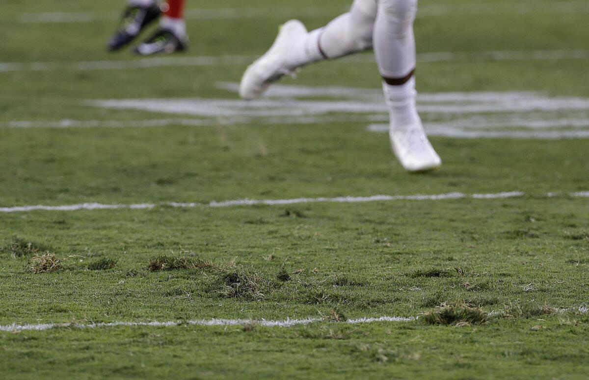 A San Francisco 49ers player runs on the torn up field at Levi's Stadium during a training camp practice on Aug. 1.