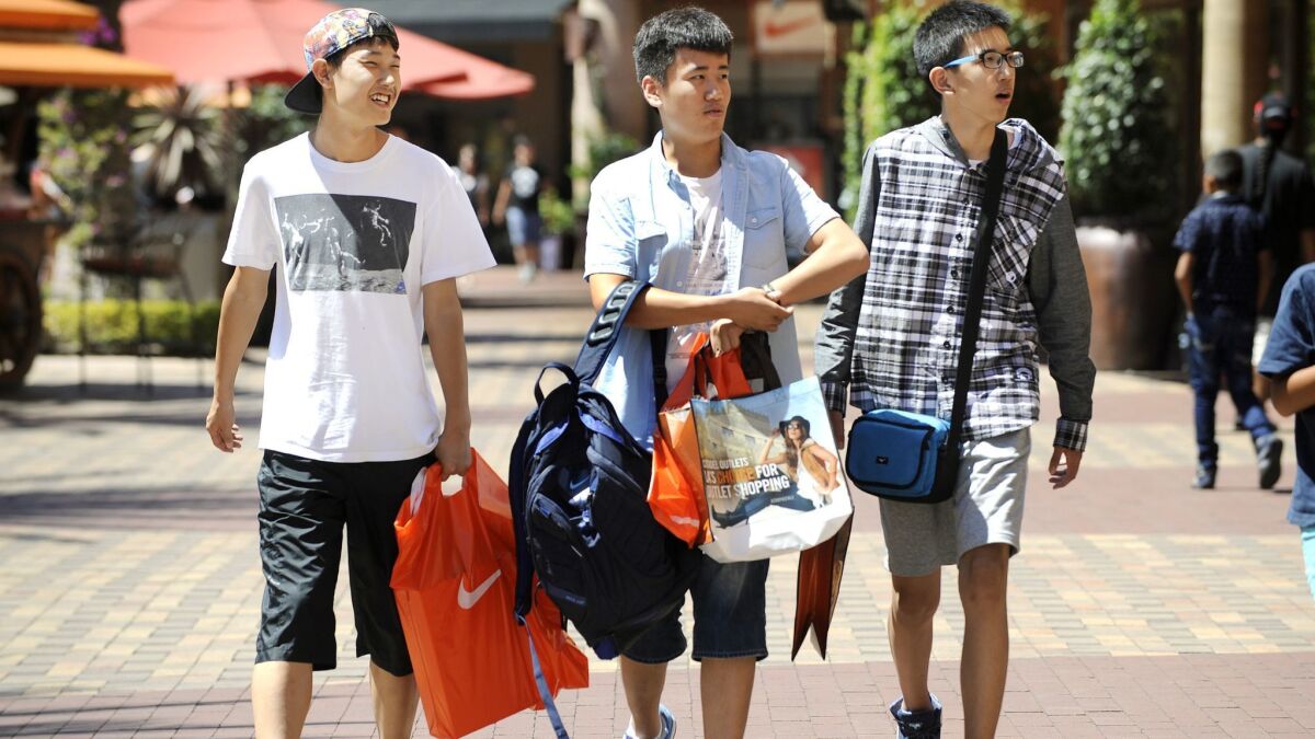 Chinese tourists shop at the Citadel Outlets in Commerce in 2015. Shopping and sightseeing are among the most popular pastimes of Chinese visitors to the U.S.