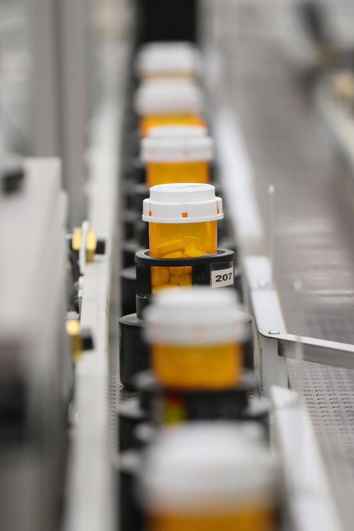 Bottles move down an automated line at Intermountain Heathcare in Midvale, Utah, one of the group of hospitals and philanthropies that launched Civica Rx, a nonprofit generic drug company.