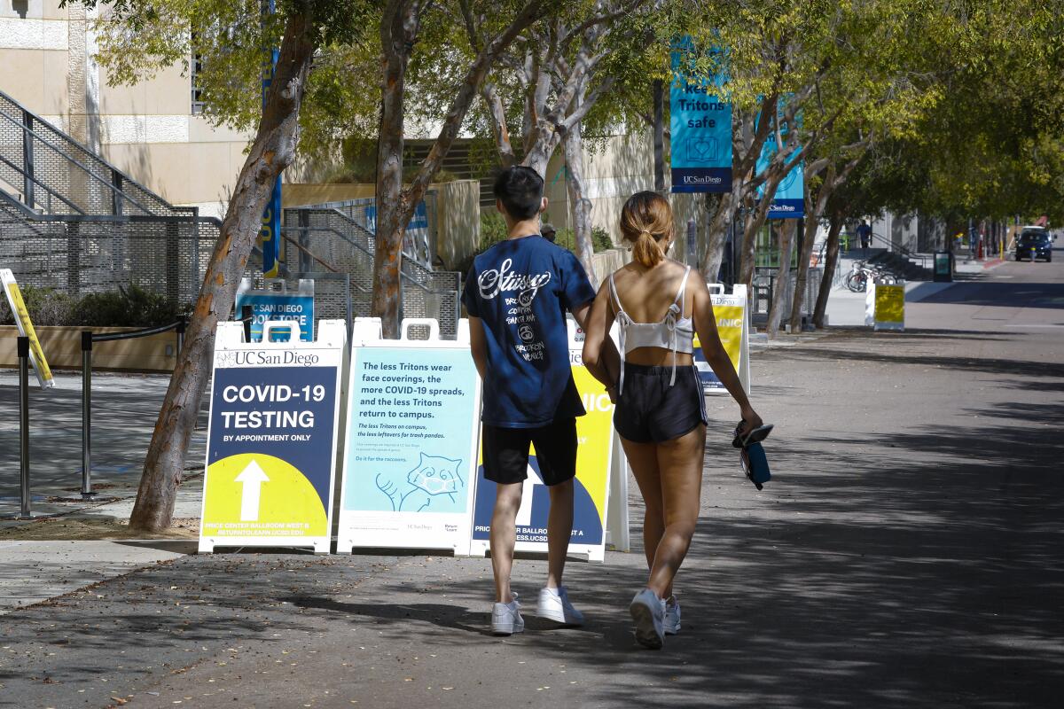 Signage and banners hang from the light poles reminding students and staff to keep safe at UC San Diego.