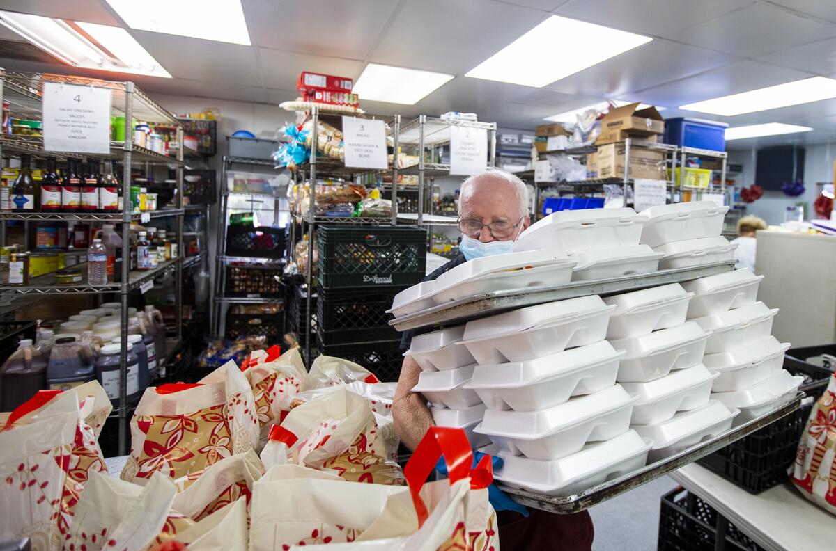 Mike Harrison, a volunteer at Mary's Kitchen in Orange, prepares meals for the homeless on Tuesday, July 13.