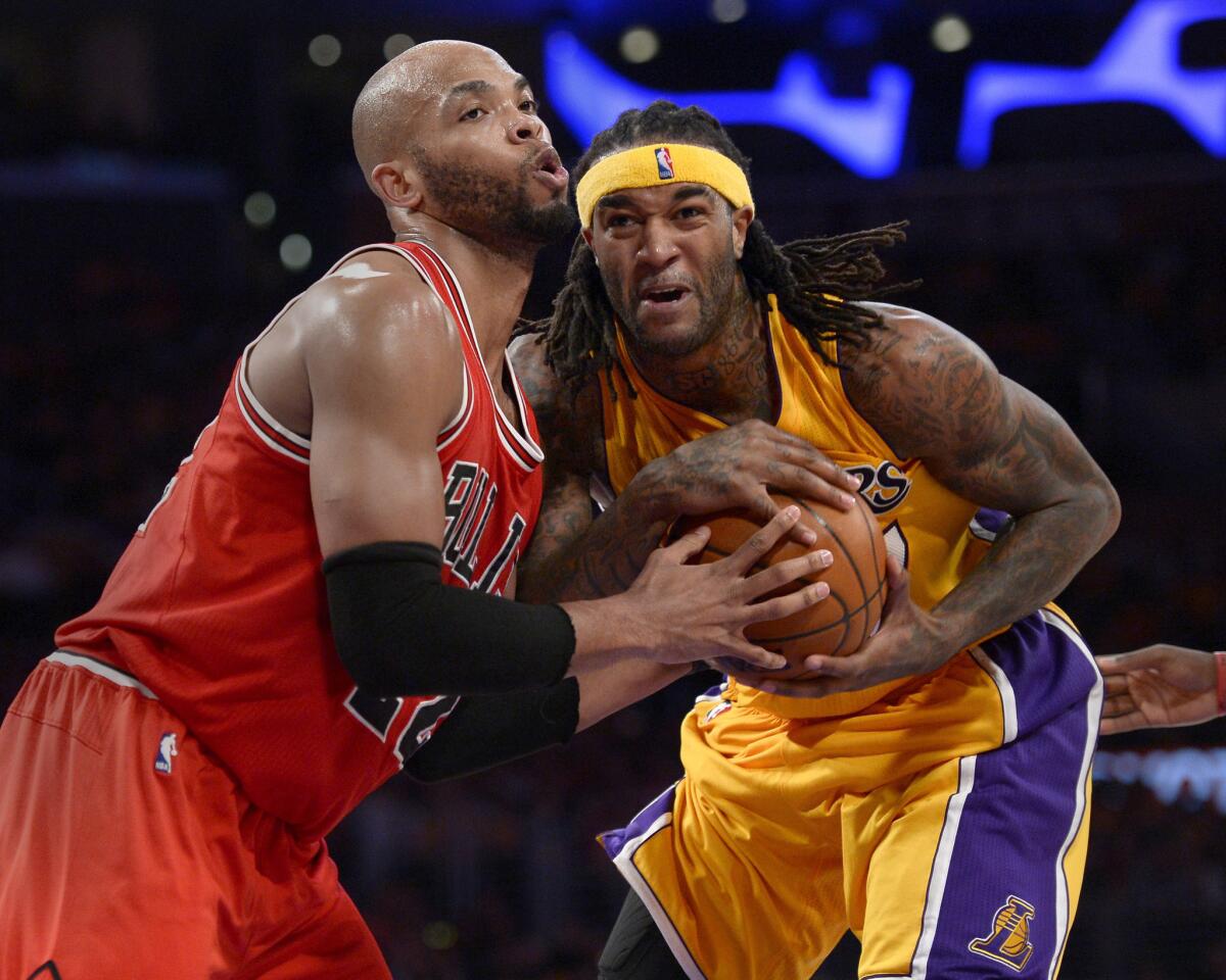 Lakers center Jordan Hill battles Bulls forward Taj Gibson for possession of the basketball in the second half.
