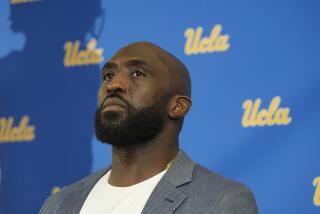 Former UCLA great DeShaun Foster is introduced as the schools new NCAA college football head coach at Pauley Pavilion in Los Angeles on Tuesday, Feb. 13, 2024. (AP Photo/Damian Dovarganes)