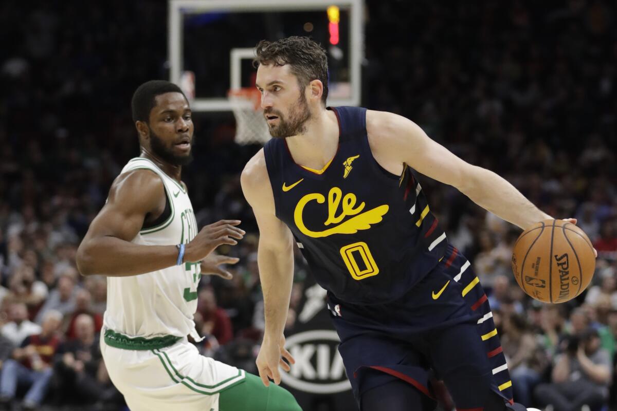 Cavaliers forward Kevin Love drives against Celtics forward Semi Ojeleye during an NBA basketball game on March 4, 2020.