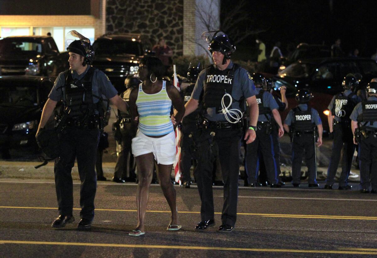 Officers arrest a protester Monday night in Ferguson, Mo.