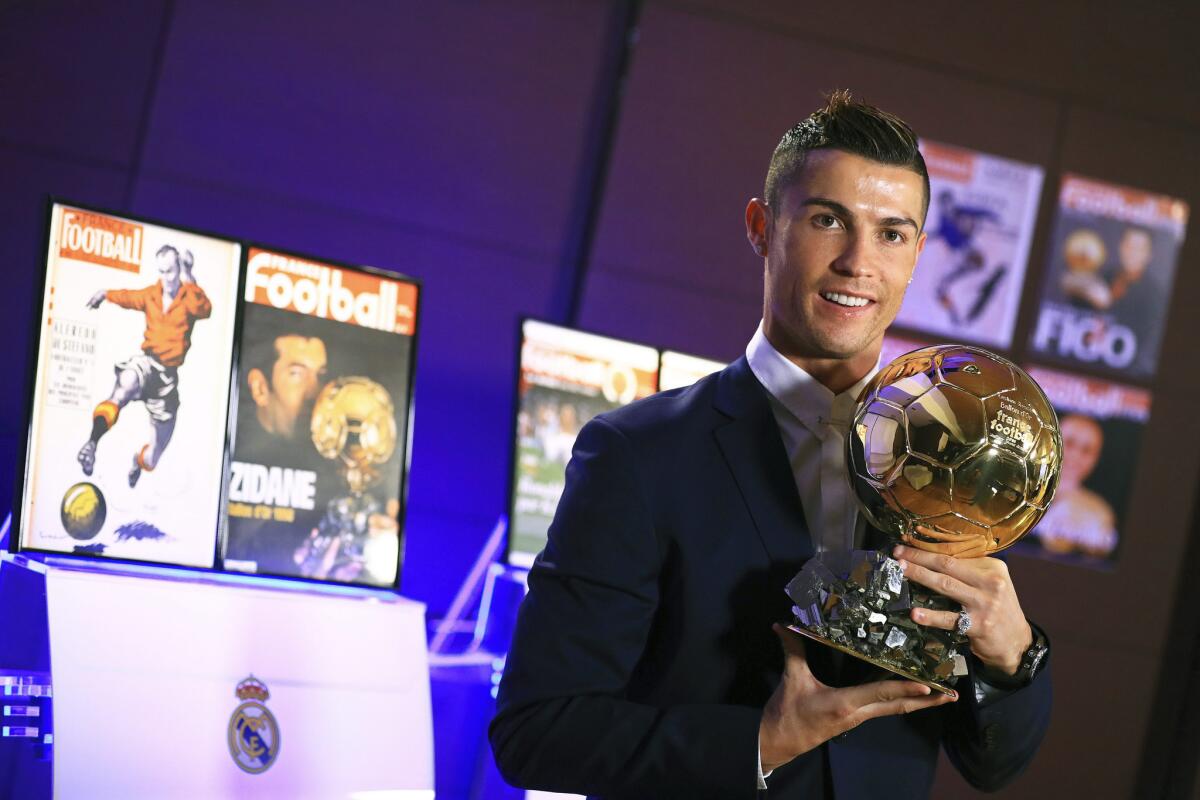 Real Madrid and Portugal striker Cristiano Ronaldo poses with the Ballon d'Or 2016 trophy on Dec. 8.