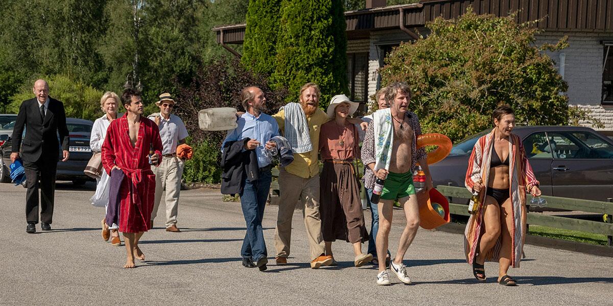 A group of people walking down a road