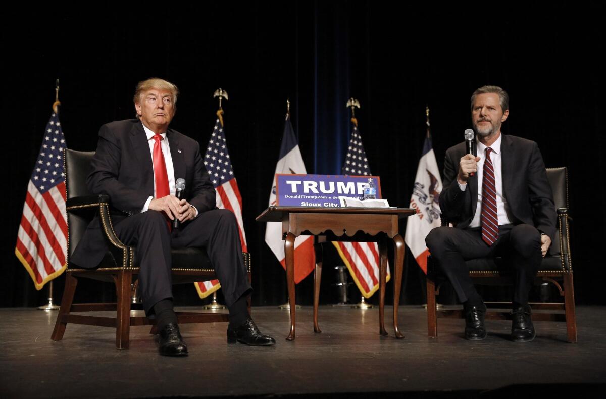 Republican presidential candidate Donald Trump, left, speaks alongside Jerry Falwell, Jr., president of Liberty University, during a campaign event at the Orpheum Theatre in Sioux City, Iowa, Sunday, Jan. 31, 2016.