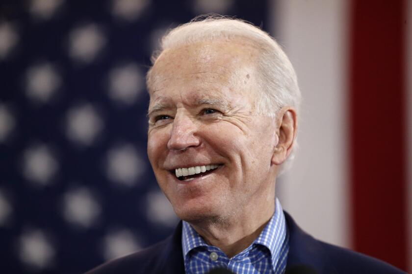 FILE - In this Feb. 22, 2020, file photo, Democratic presidential candidate former Vice President Joe Biden speaks during a caucus night event in Las Vegas. Biden's tenure as Barack Obama's vice president is complicating his efforts to deepen ties with Latinos who could be critical to winning the White House. For many Latinos, Biden's embrace of the Obama years is a frightening reminder of when the former president ejected about 3 million people living in the U.S. illegally, earning him the moniker of “deporter in chief.” (AP Photo/John Locher, File)