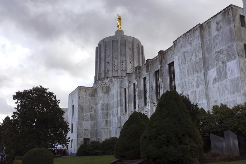 FILE - This Jan. 11, 2018, file photo, shows the state Capitol in Salem, Ore. Oregon has abandoned a requirement that restricted the use of its first-in-the-nation death-with-dignity law to residents of the state, after a lawsuit challenged the requirement as unconstitutional. (AP Photo/Andrew Selsky, File)