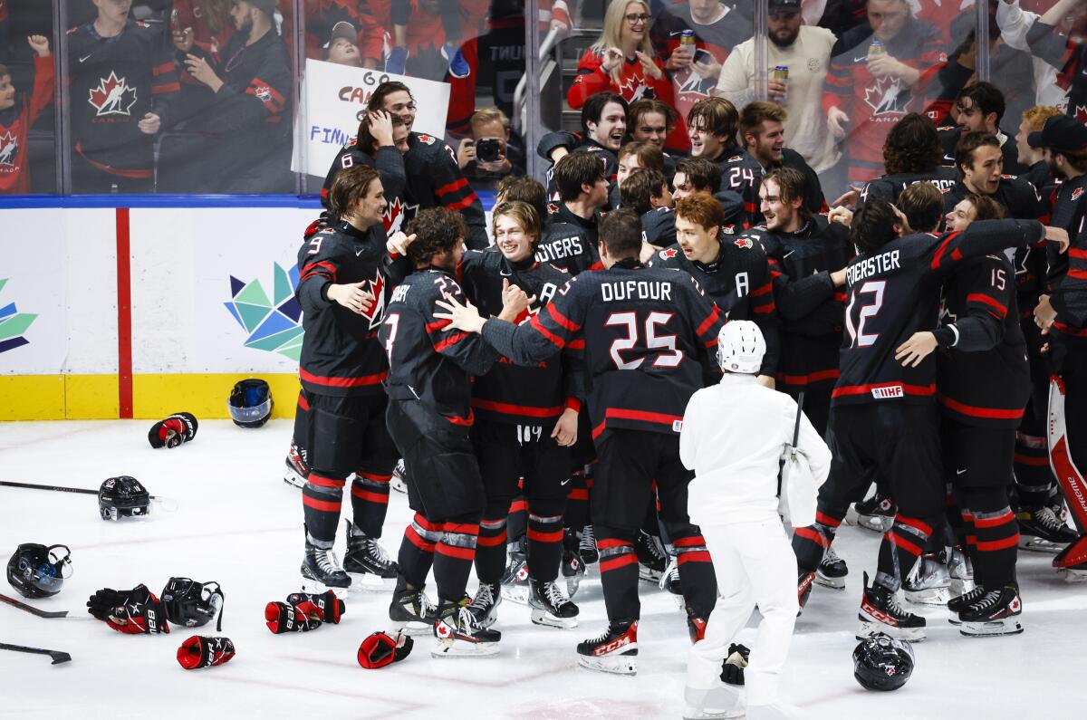 Canada celebrates defeating Finland during overtime in the gold medal game at the world junior hockey championship, Saturday, Aug. 20, 2022 in Edmonton, Alberta. (Jeff McIntosh/The Canadian Press via AP)