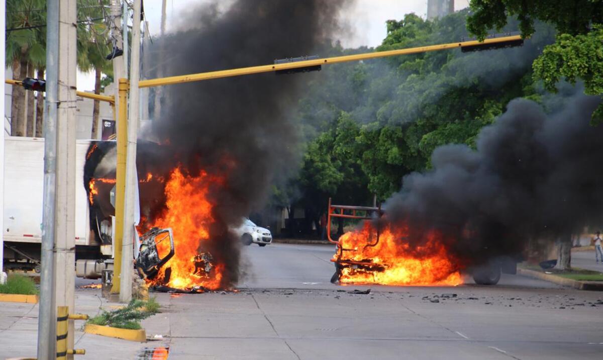 Vehicles burn on a city street