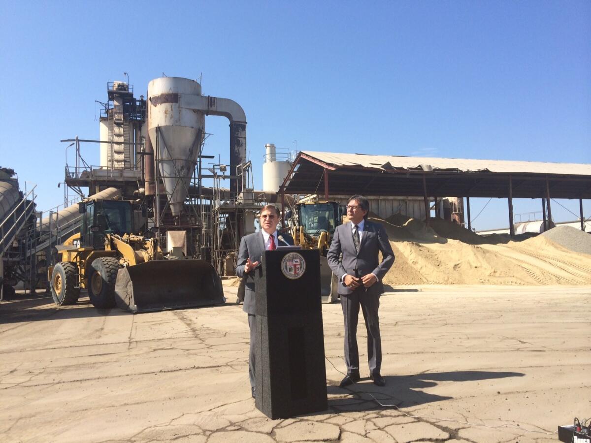 City Controller Ron Galperin and Bureau of Street Services Director Nazario Sauceda discuss the findings of an audit of the agency outside a city asphalt plant in downtown Los Angeles on Thursday.