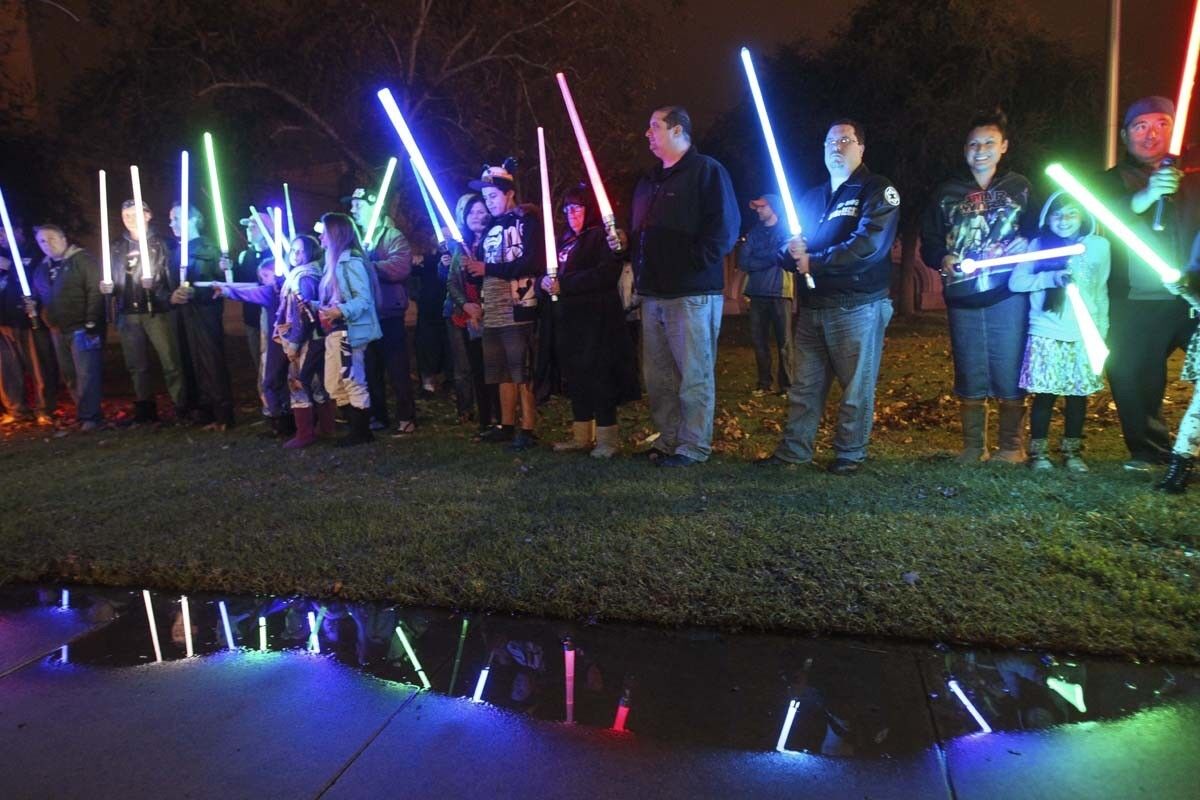 ESCONDIDO, December 30, 2016 | Around fifty Star Wars fans hold their lightsabers before raising them up in tribute to actress Carrie Fisher, who played Princess Leia in the movie, at the California Center for the Arts in Escondido on Friday. | Photo by Hayne Palmour IV/San Diego Union-Tribune/Mandatory Credit: HAYNE PALMOUR IV/SAN DIEGO UNION-TRIBUNE/ZUMA PRESS San Diego Union-Tribune Photo by Hayne Palmour IV copyright 2016