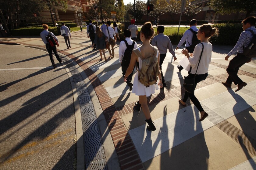 UCLA students make their way to class Monday in the heat. A low-pressure system combined with a plume of sub-tropical moisture will bring showers and possibly thunderstorms starting Monday night.