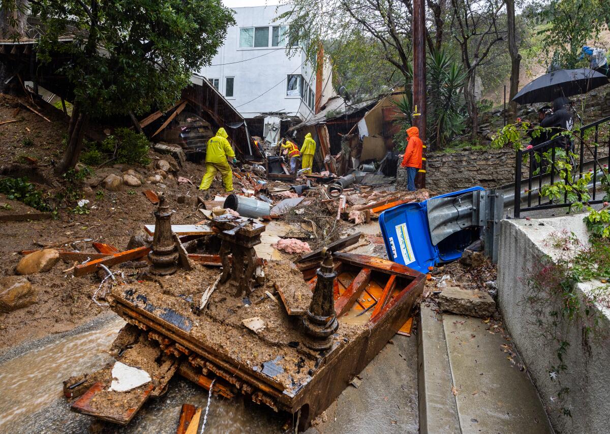 A grand piano lies upside down in the middle of Caribou Lane near a Beverly Crest home that was pushed off its foundation.