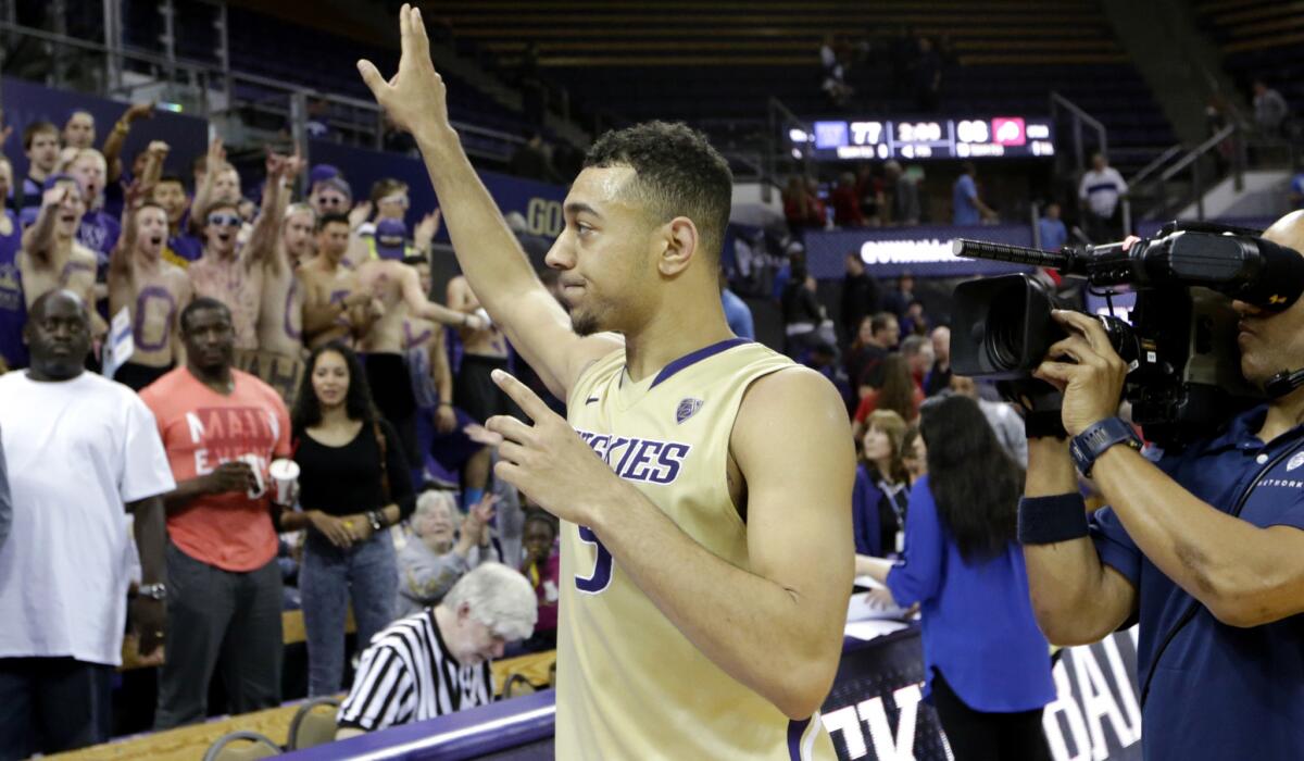 Washington guard Nigel Williams-Goss waves at spectators after helping the Huskies defeat Utah on Saturday.