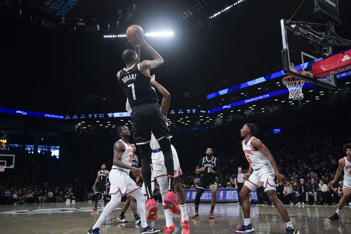 Brooklyn Nets' Kevin Durant (7) pulls up for a shot during the second half of the NBA basketball game against the New York Knicks at the Barclays Center, Sunday, Mar. 13, 2022, in New York. The Nets defeated the Knicks 110-107. (AP Photo/Seth Wenig)
