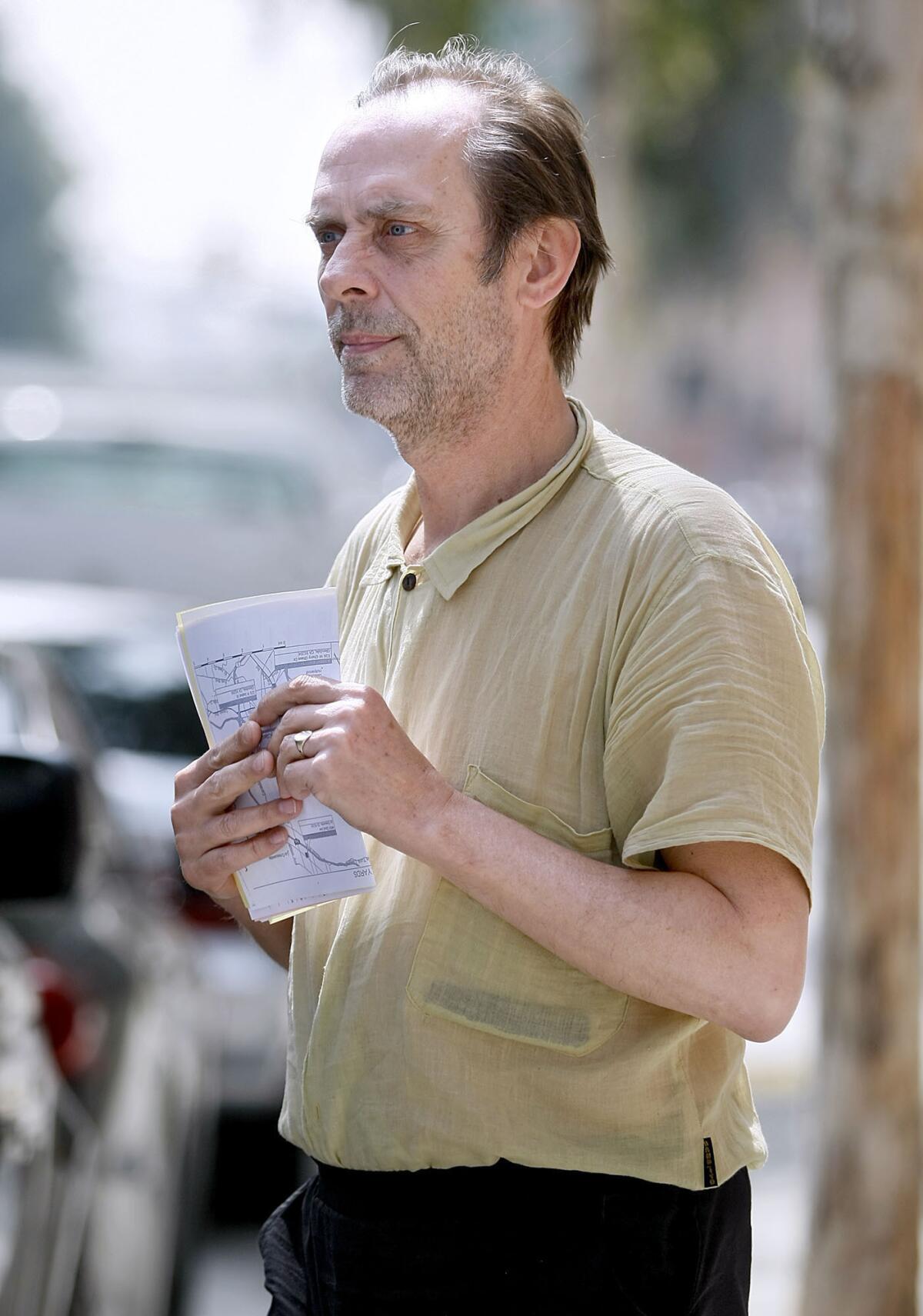 GothÃ‚Â¿rocker Peter Murphy holds paperwork as he comes out of the Glendale jail on Tuesday, March 19, 2013. The Bauhaus band lead singer spent the weekend in Jail after crashing his car into another one in Glendale on Saturday.