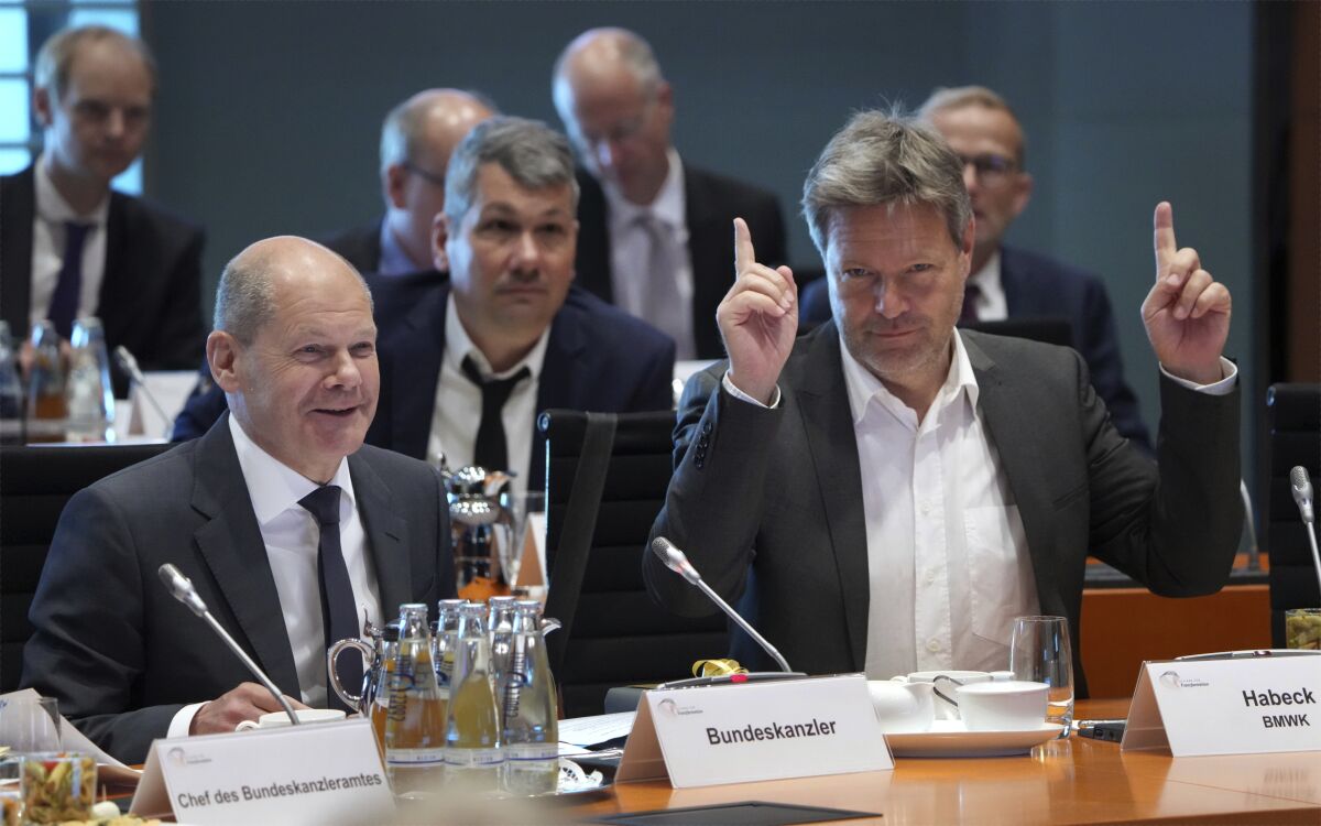 German Economy and Climate Minister Robert Habeck, front right, point up as German Chancellor Olaf Scholz, front left, opens the 'Alliance For Transformation' summit at the Chancellery in Berlin, Germany, Tuesday, June 14, 2022. (AP Photo/Michael Sohn, pool)