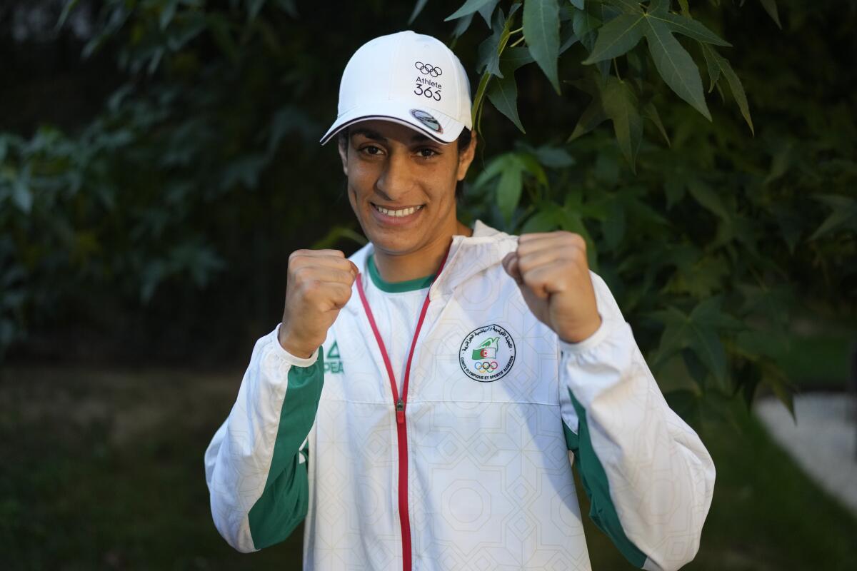 Algerian boxer Imane Khelif poses for a photo after an interview with SNTV at the 2024 Summer Olympics Sunday in Paris.