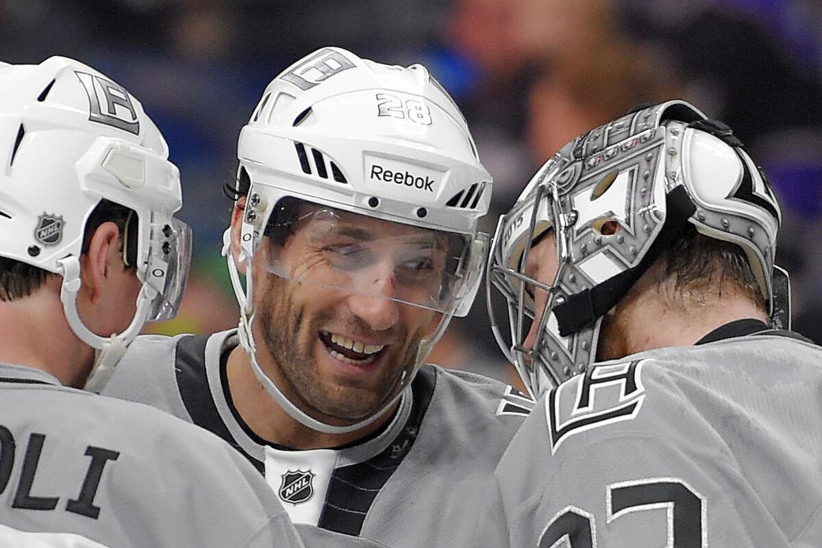 Kings forward Jarret Stoll, center, congratulates goalie Jonathan Quick, right, after a game against the San Jose Sharks on April 11.