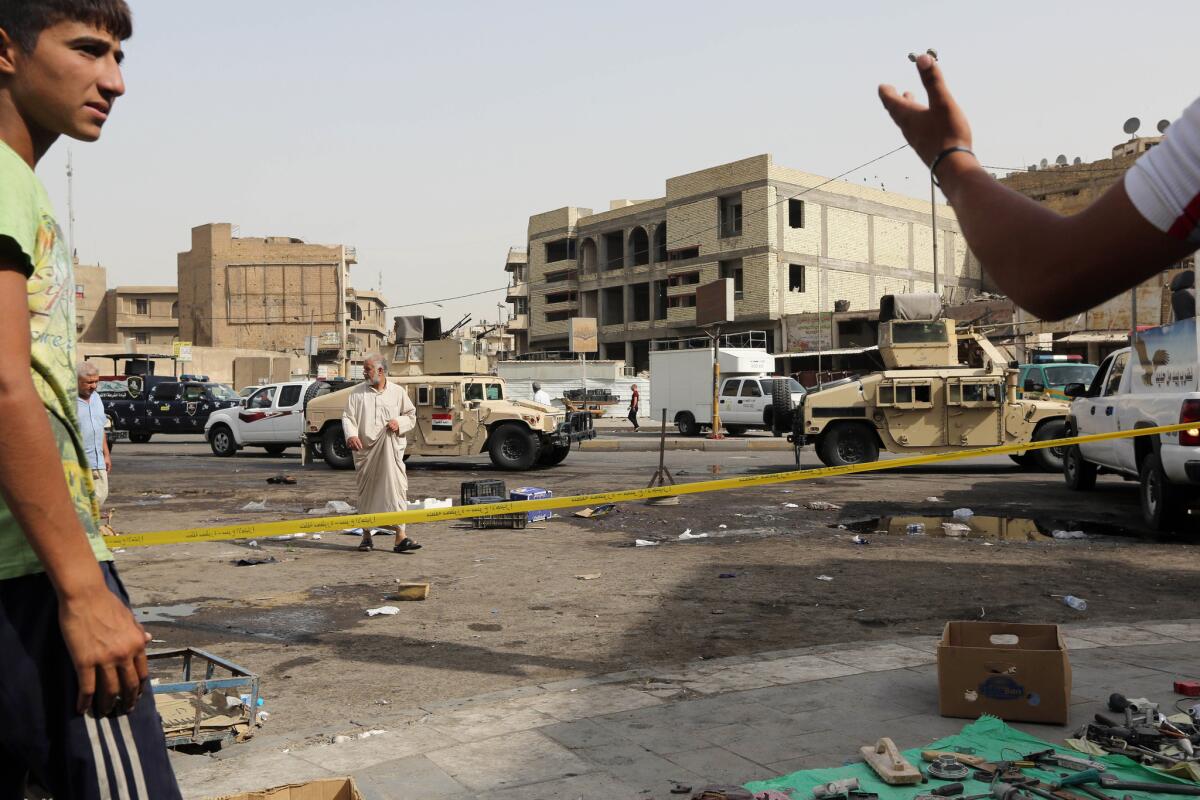 Residents and security forces gather at the site of a suicide bomb attack in Baghdad on Sept. 17.