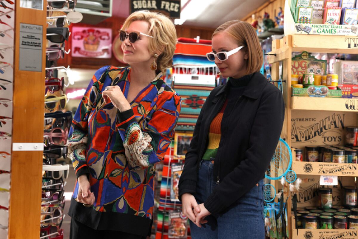 Two women try on sunglasses