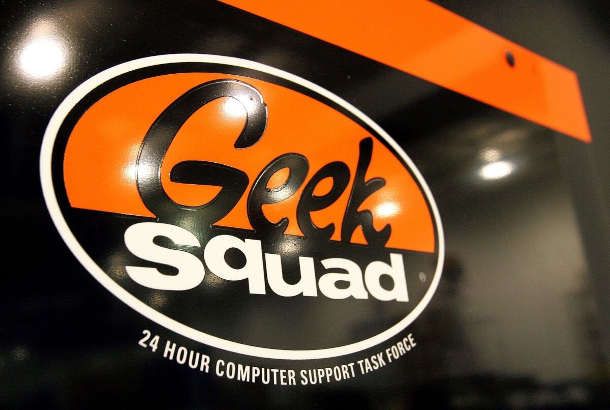 A "Geek Squad" sign hangs on a door at its computer repair facility in a Best Buy store in Niles, Ill.