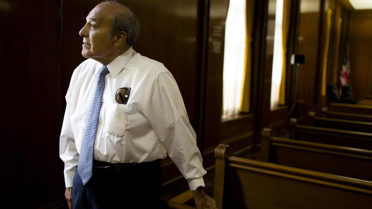 Henry Gonzalez looks out a window inside the council chambers. He was South Gate's first Latino council member and mayor, and he will leave the city drastically different from the South Gate that made news.