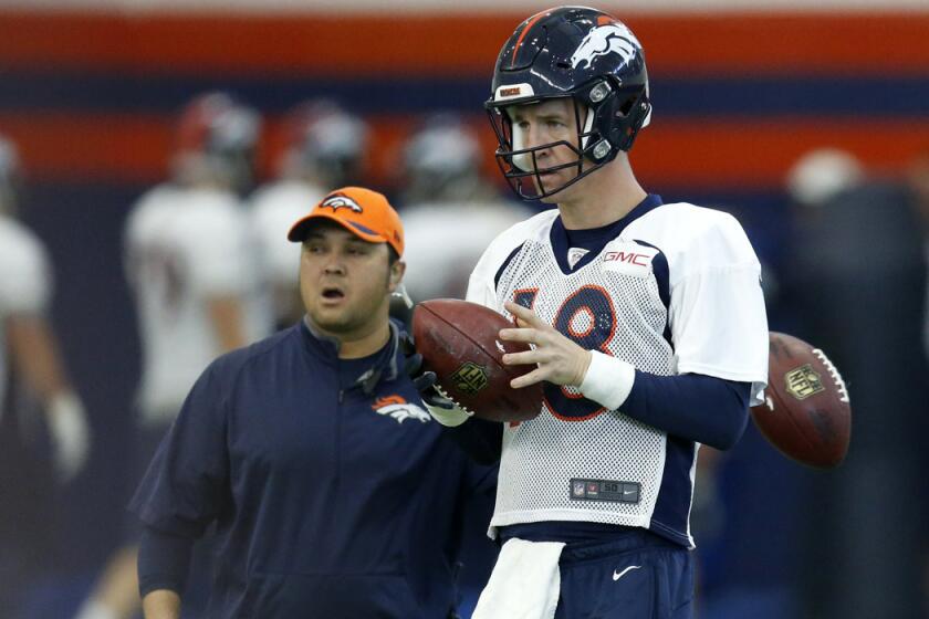 Denver Broncos quarterback Peyton Manning warms up during practice at the team's headquarters on Wednesday.