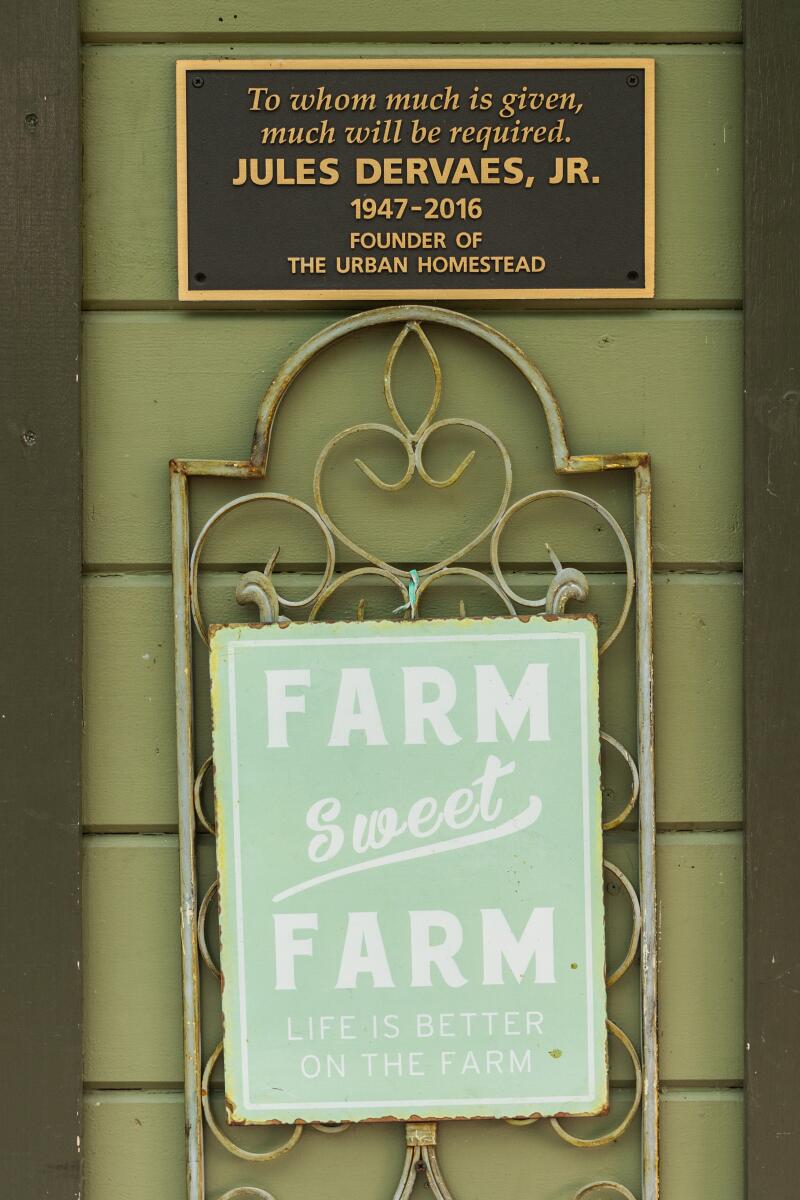  A plaque memorializes Jules Dervaes Jr. above the words Farm Sweet Farm